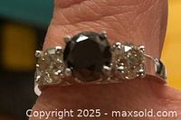 Ring showing three-stone setting on finger