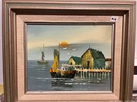 Full view of framed coastal oil painting