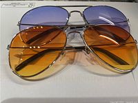 Both pairs of sunglasses front view showing lens colors and frames