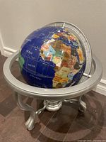 Globe on silver metal stand full view