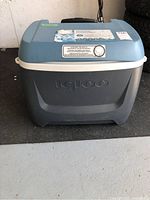 Front view of blue and gray Igloo cooler with built-in dial and embossed logo on lid and body.