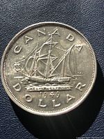Reverse side of the 1949 Canadian silver dollar featuring the Bluenose schooner and inscriptions
