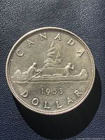 Reverse side showing canoe with two paddlers, year 1953 and inscriptions