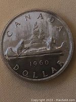 Obverse side showing the canoe design with the year 1960 and 'CANADA DOLLAR'