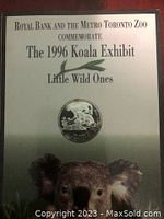 Photo showing display card with coin and text 'Royal Bank and the Metro Toronto Zoo commemorate The 1996 Koala Exhibit Little Wild Ones'.