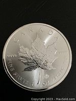 Obverse side of the coin showing a maple leaf and text indicating 1 oz of fine silver with purity 9999.