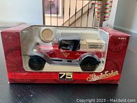 Front view of the boxed 1922 Studebaker Big Six pickup diecast truck showing red and black paint with Canadian Tire branding in beige pickup bed and 75th Anniversary logo on box.