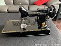 Front-left side view of sewing machine on table