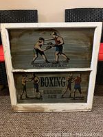 Full view of the old window frame containing two reverse painted glass panels depicting boxing scenes and texts.