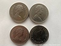 Obverse side of four Canadian dollar coins showing Queen Elizabeth II portraits and dates 1969, 1978(x2), and 1984