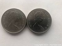 Obverse side of two British commemorative coins showing Queen Elizabeth II profile portraits.