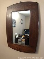 Front view of a vintage solid oak framed rectangular mirror with slightly arched top edge, in very good condition.
