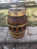 Full image of the vintage wagon wheel hub lamp showing wood and metal bands with hanging chain