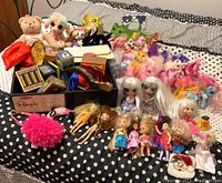 Wide view of the entire lot including Melissa & Doug magic kit wooden box and blocks, dolls, My Little Ponies, and various small purses and stuffed animals.