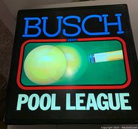 Front view of the illuminated bar light showing Busch Beer branding with pool theme graphics and Pool League text in bright colors.