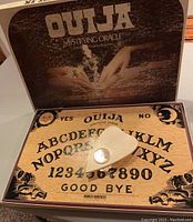 Vintage 1972 Parker Brothers Ouija board in box with planchette sitting on the board