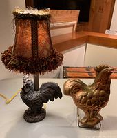 Rooster lamp with fabric shade and copper rooster jello mold displayed together