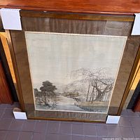 Full view of the framed vintage painting on silk showing the river, tree, and background.