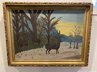 Frontal view of the framed painting showing three deer in the snow landscape with a sunset and mountains in background.