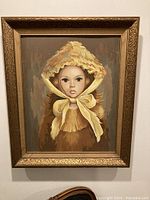 Overall view of the framed painting showing the entire portrait of a girl with a bonnet.