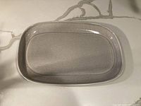 Top view of the rectangular platter showing shape, size and speckled gray glazed surface.
