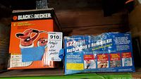Photo showing sealed Black & Decker orbital polisher box next to EZ Chill AC recharge and retrofit kit box.