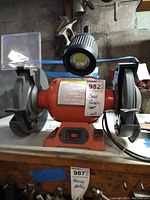Front view of the Central Machinery 8-inch bench grinder with mounted LED light and safety shields on both grinding wheels.