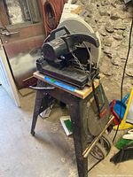 Side view of the Craftsman chop saw on its stand showing the motor and blade guard.
