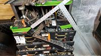 Photo showing multiple metal T-squares and angle squares with measuring marks, placed on drawers containing assorted small metal parts and tools.