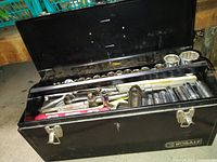 Open-top view of tray showing assorted sockets, ratchets, socket extensions, and level