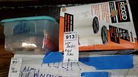 Ridgid wet/dry vac filter box alongside plastic container labeled for wire brushes.