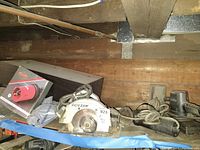 View of the Skil circular saw, handheld sanders, and other assorted tools on a wooden surface.