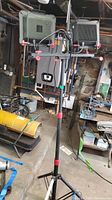 Overall front view of Husky dual work lights on adjustable tripod stand in basement workspace