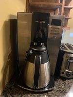 Photo showing Mr. Coffee drip coffee maker and Black & Decker toaster side by side on counter