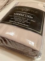 Close-up of the Hotel Style waterproof fabric shower liner packaging showing size, material, and features.