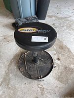 View of stool showing black vinyl cushioned seat with Northern Industrial Tools logo and price tag.