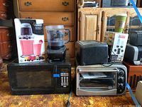 Photo showing overall lot contents with the appliances arranged on a counter
