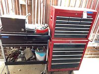 Front view of bottom chest, top chest and tool cart loaded with bins and tools