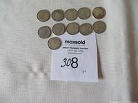 Overview photo showing all 11 Canadian silver dimes arranged in two rows above a MaxSold auction card marked 308H.