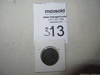 Coin in 2×2 cardboard holder with MaxSold lot sticker