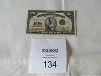 Full view of banknote on white background with lot number card