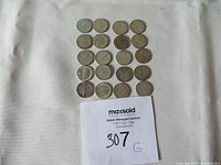 Twenty Canadian silver dimes arranged in rows showing both sides, including the Confederation fish design on 1967 coins and standard walking figure design on others.