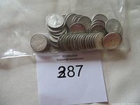 Plastic bag containing approximately 50 Canadian silver dimes from the 1950s and 1960s, all circulated.