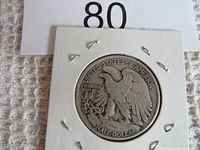 Photo of reverse side of 1943 Walking Liberty half dollar coin showing eagle, inscriptions and condition.