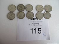 Top view of all ten Canadian silver dimes arranged in two rows showing their front design.
