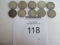 Ten Canadian silver dimes arranged in two rows on paper with lot number, showing front sides with Bluenose sailing ship design.