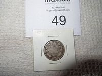 Front and back images of 1917 Canadian 25 cent silver coin in white cardboard holder showing details on the coin.