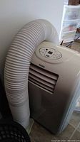 Full view of the Danby portable air conditioner unit with attached flexible exhaust hose.