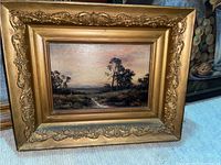 Front view of framed oil landscape painting
