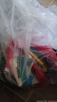 Bag containing multiple flags and windsocks in plastic bag